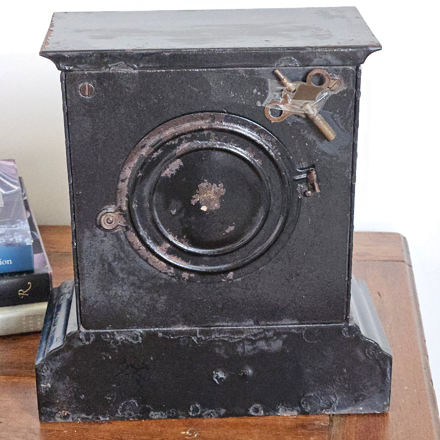 Vintage metal box camera on a wooden surface with a white background