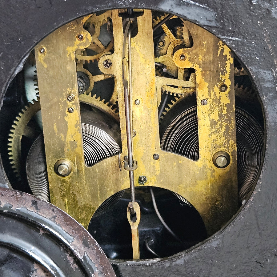 Close-up of a mechanical clock mechanism with gears and springs.